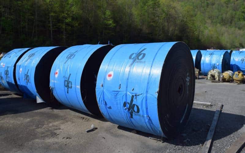 A mining conveyor belt system used to transport materials such as rocks and gravel in a mining operation.